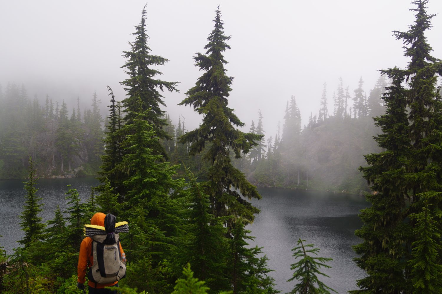 Adrian backpacking at an alpine lake